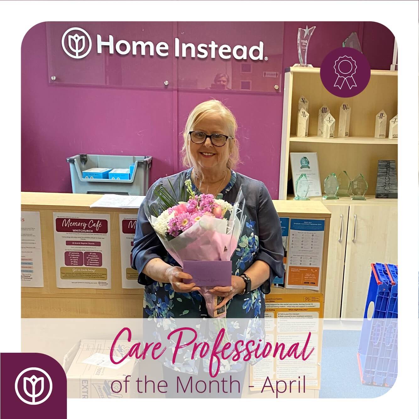 A woman holding a bouquet is recognized as "Care Professional of the Month - April" at Home Instead. - Home Instead