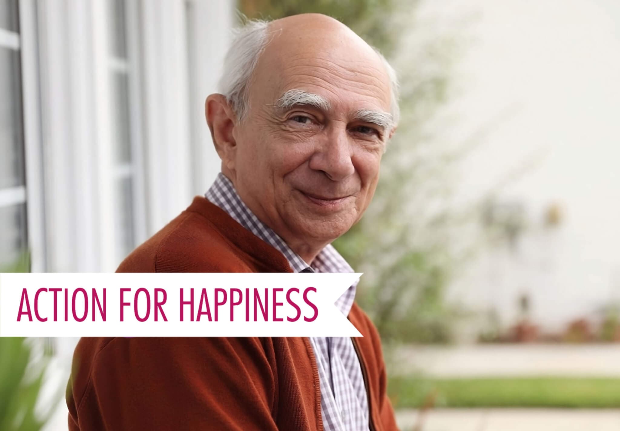 Older man smiling outdoors, wearing a brown cardigan. Text: "ACTION FOR HAPPINESS. - Home Instead