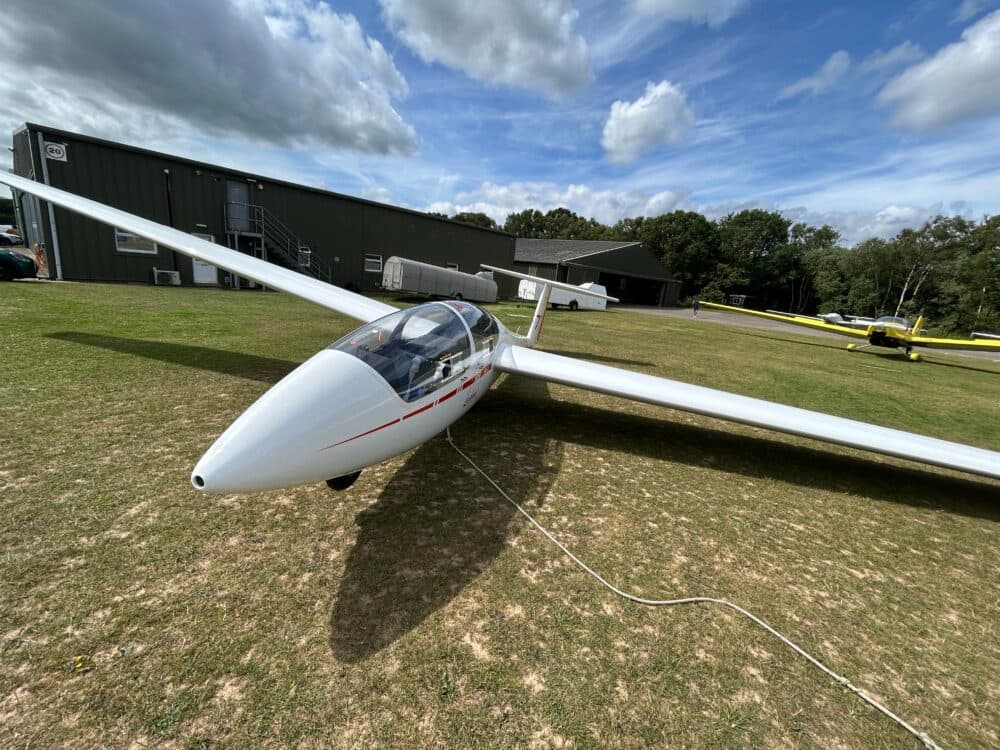 White glider on the ground at Lasham Gliding Society, Lasham Airfield.