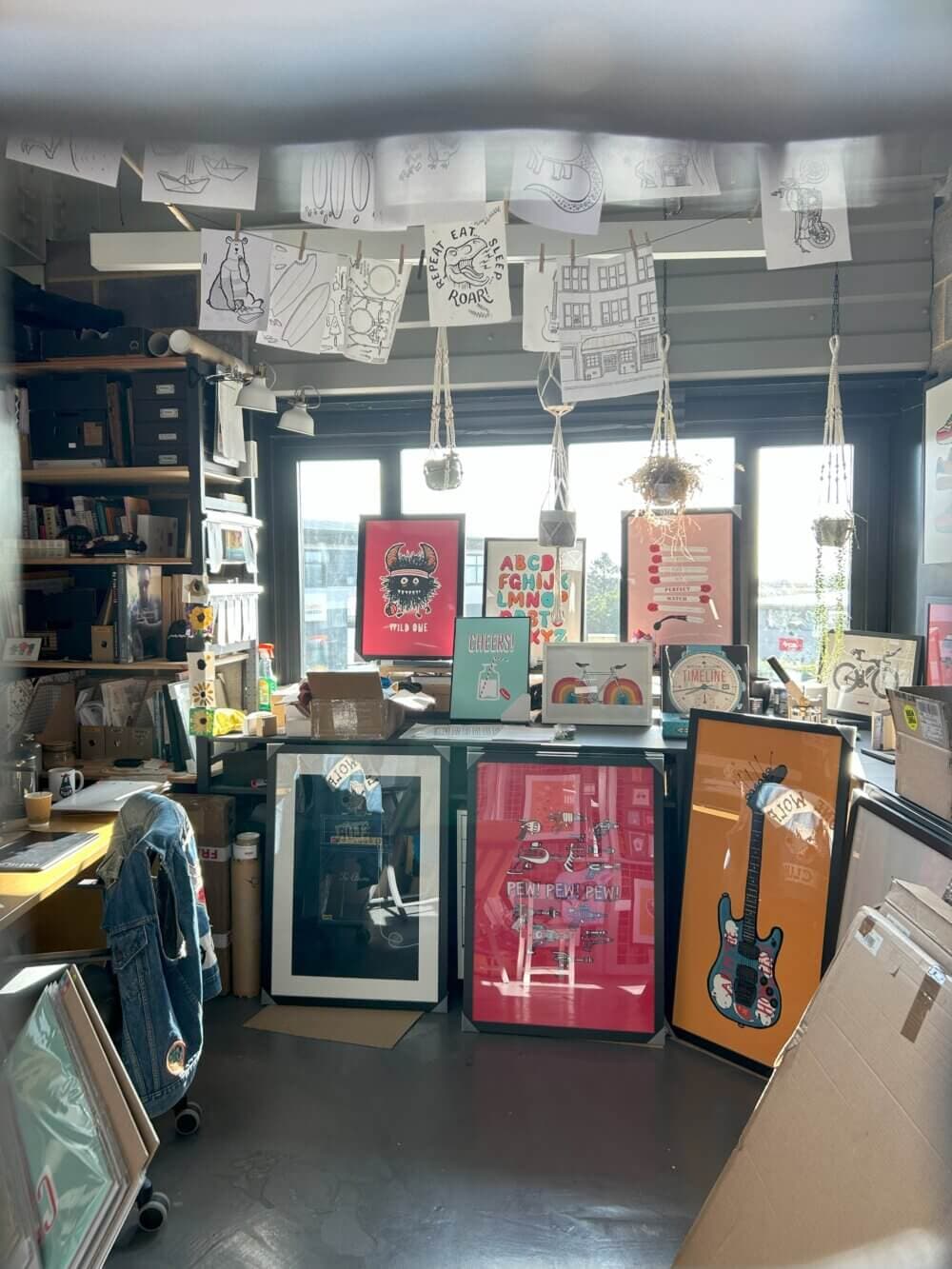 Home Instead Basingstoke picture of artists studio with posters and framed artworks at The Base, Greenham Common