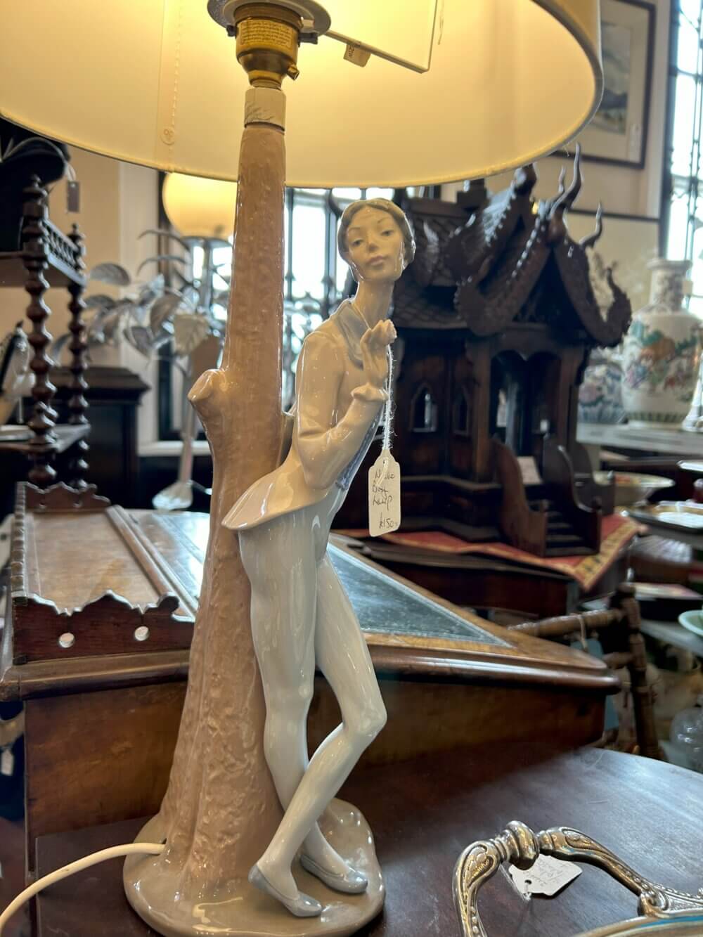 Home Instead Basingstoke picture of a ceramic lamp featuring a figure of a girl leaning against a post, at White Lion Antiques, Hartley Wintney
