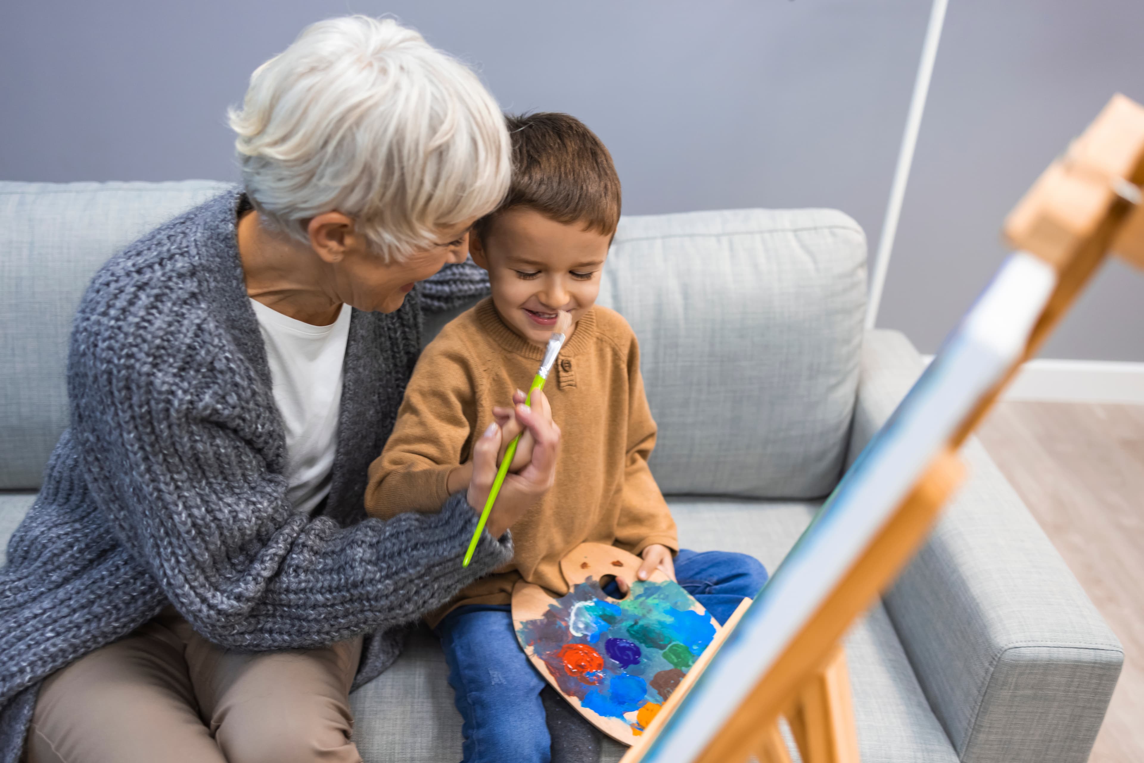 Grandmother painting with grandchild - Home Instead