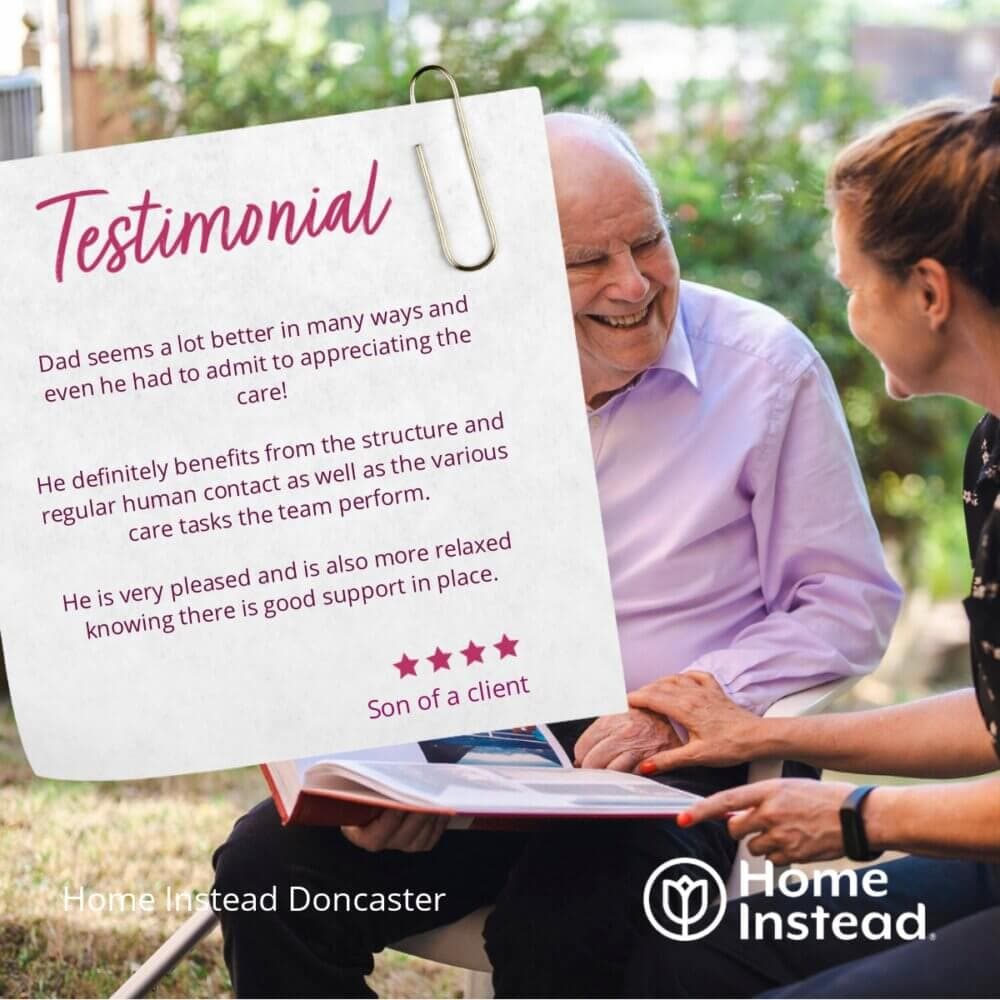 An elderly man and a woman smile while looking at a photo album. A testimonial is superimposed on the image. - Home Instead