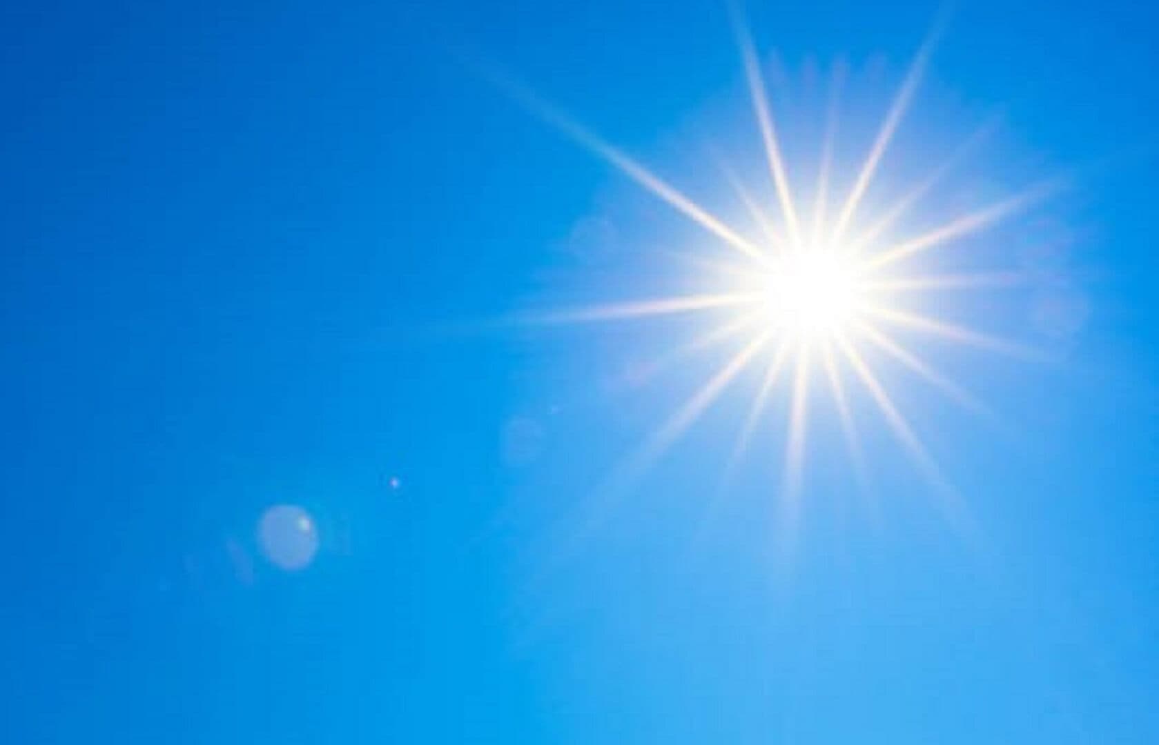 Bright sun with rays shining in a clear blue sky. - Home Instead