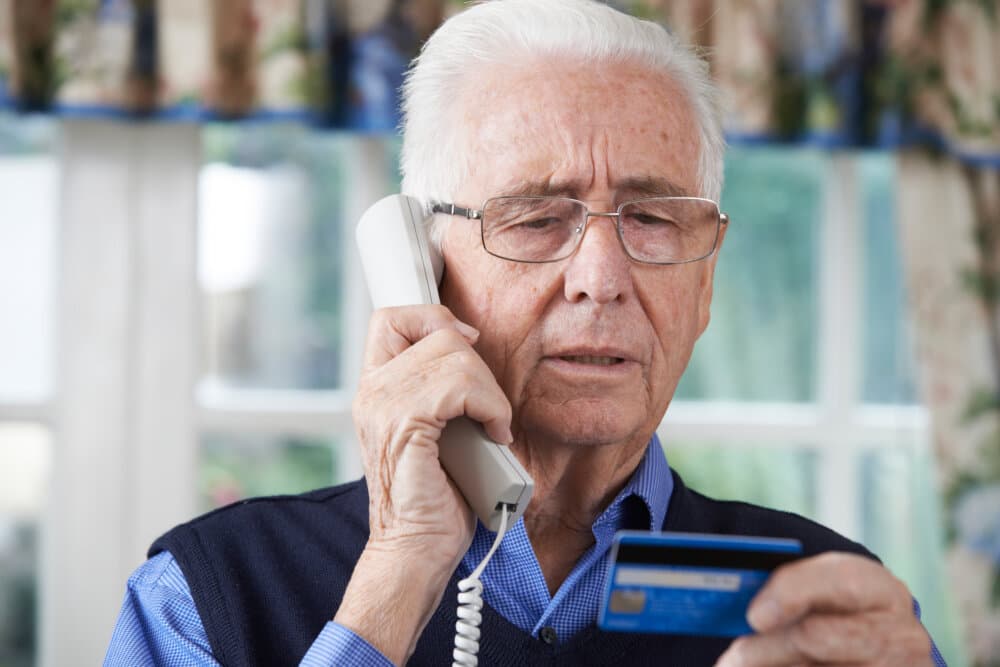 Elderly man giving credit card details out over the phone - Home Instead