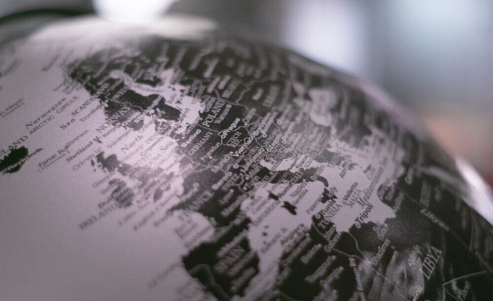 A close-up of a globe showing parts of Europe, including France, Germany, Italy, and Poland with labels and borders. - Home Instead