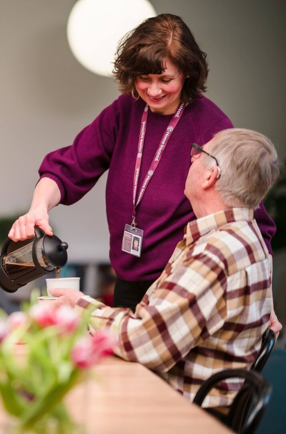 Home Instead Care Professional pouring coffee for happy client