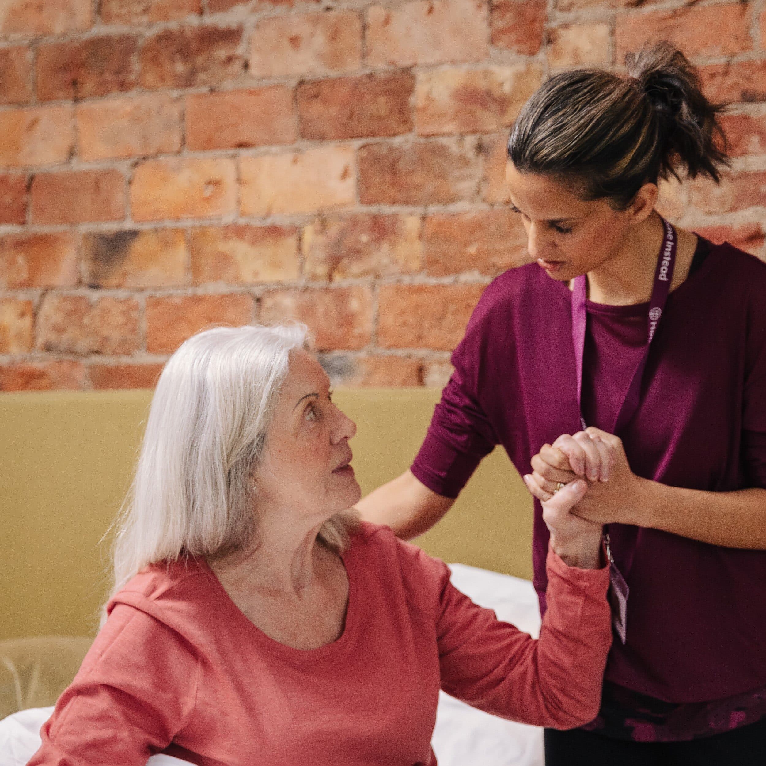 Home Instead carer helping her Home Instead client with her morning routine