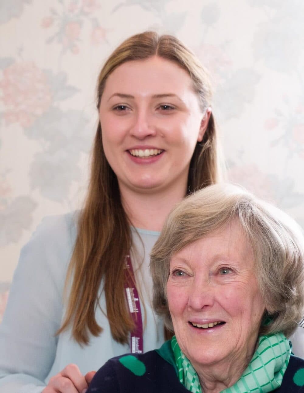 Home Instead live-in carer brushing the hair of her Home Instead live-in care client