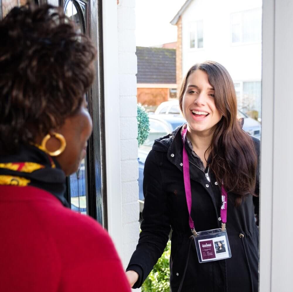 Home Instead client greets her Home Instead carer at the front door