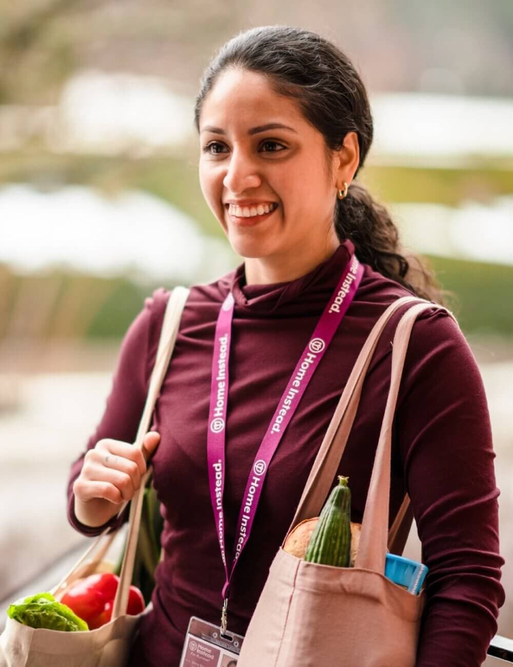 Two men wearing glasses doing dishes in a kitchen, chatting and smiling at each other. - Home Instead