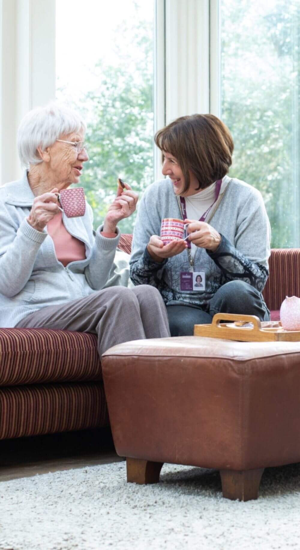 Home Instead Poole Care Professional enjoying some biscuits with client