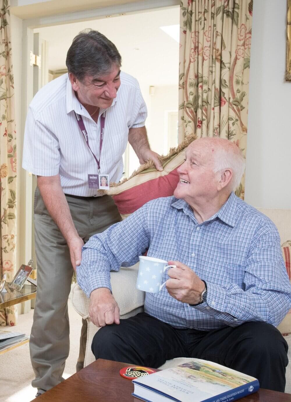Home Instead Bournemouth & Christchurch Care Professional with client enjoying a cup of tea