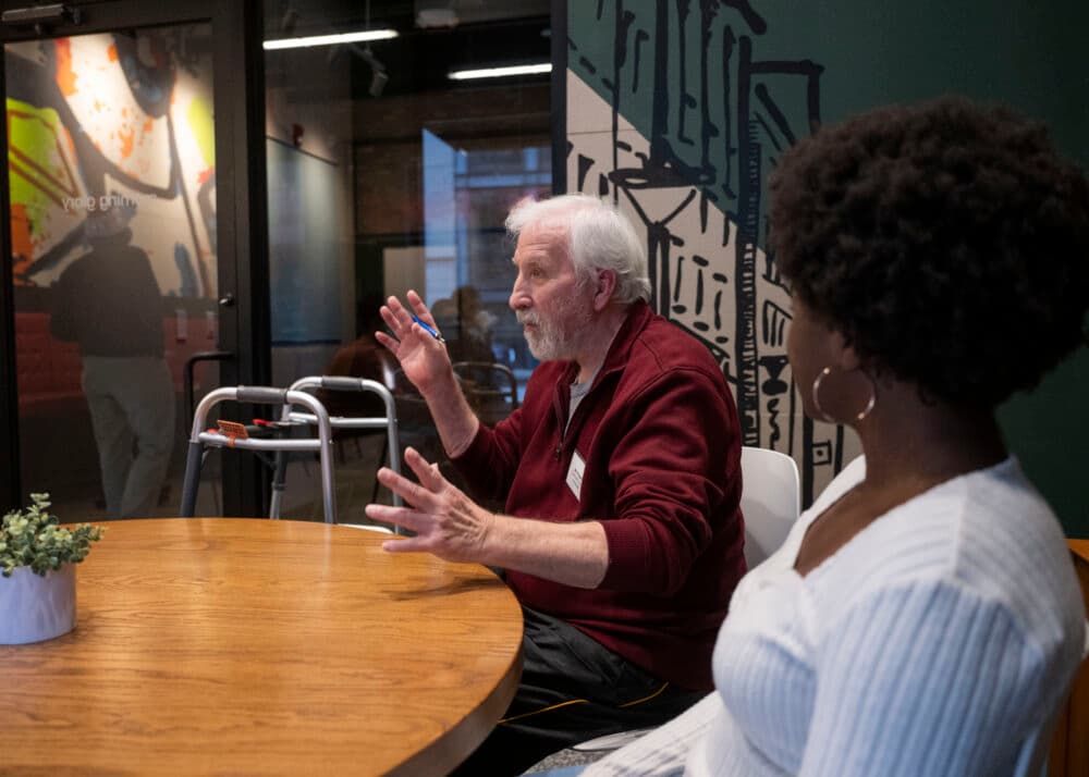 An elderly man with a young woman talking - Home Instead