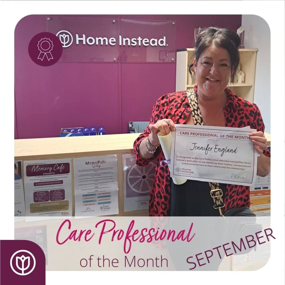 Woman smiling and holding a "Care Professional of the Month" certificate. "September" text is displayed below. - Home Instead