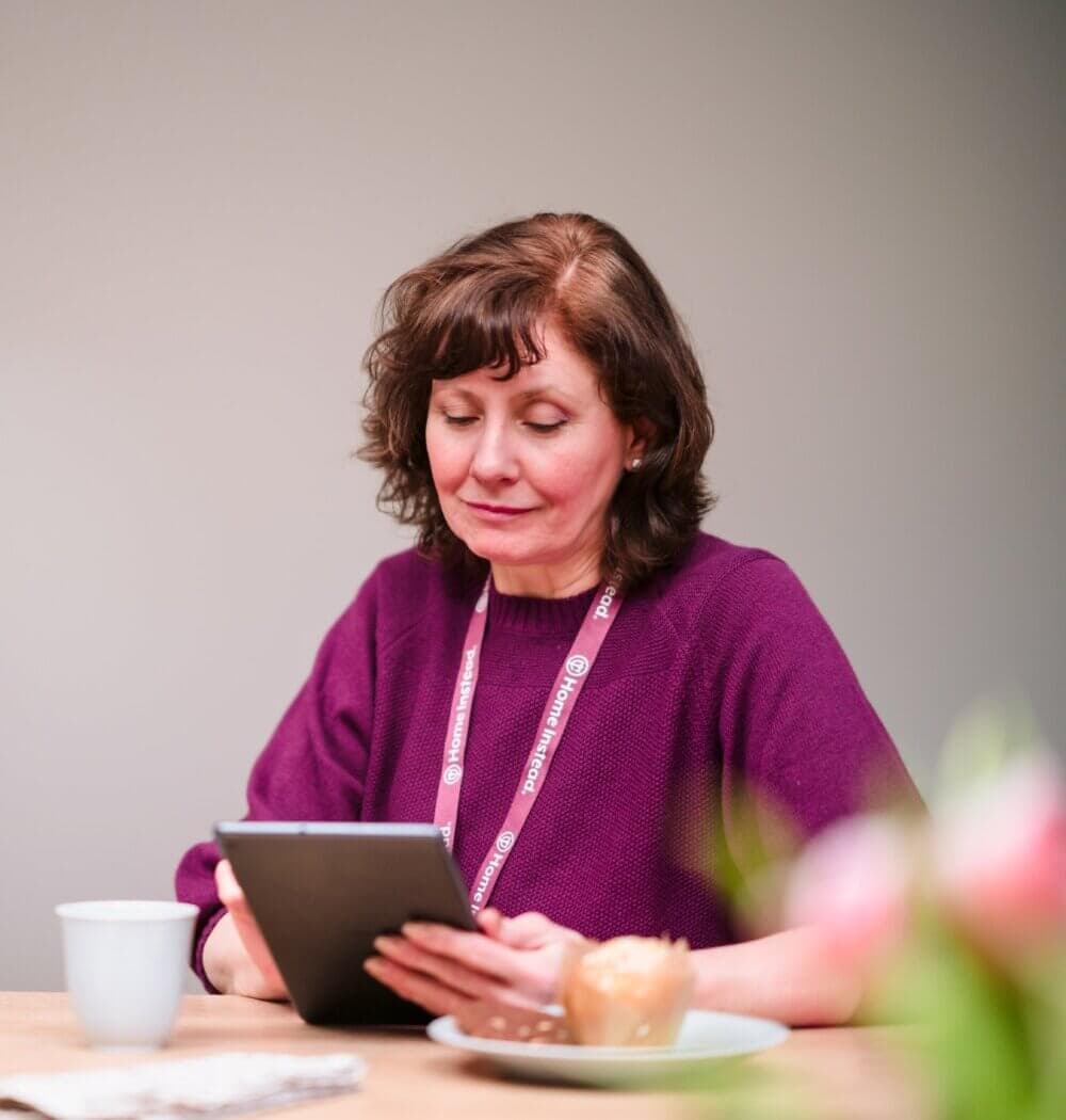 Home Instead Southampton Care Professional using tablet