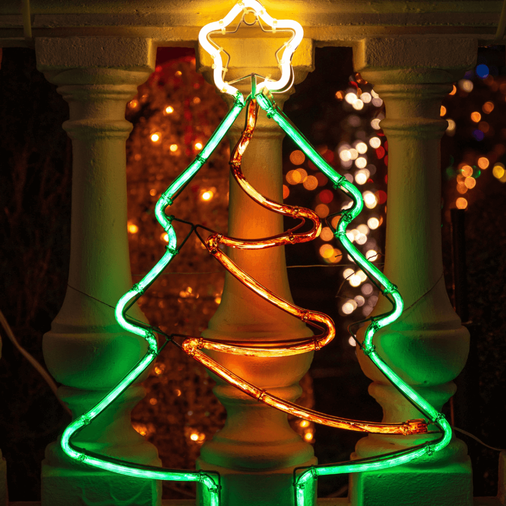Neon Christmas tree decoration with a star on top, glowing green and orange, set against a festive background. - Home Instead