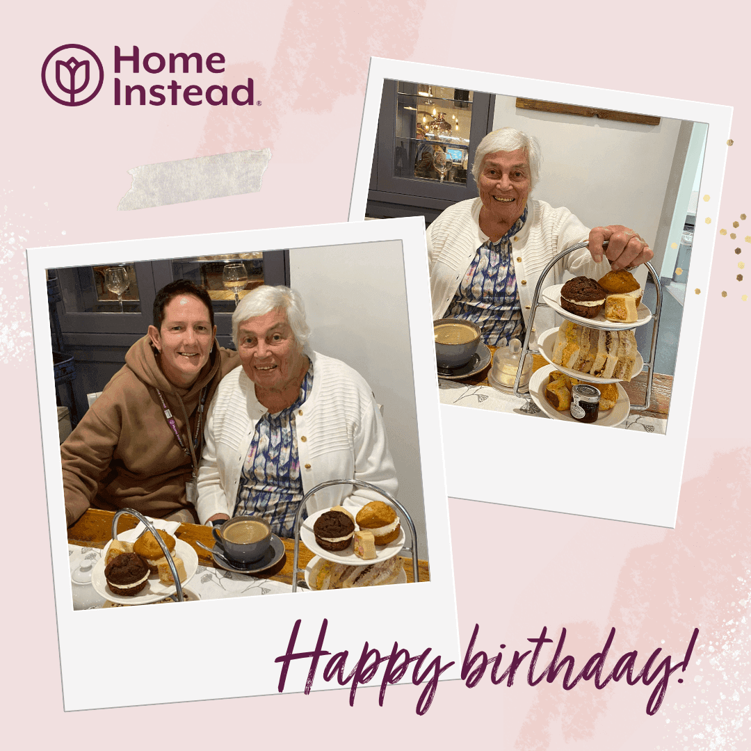 Two people smiling with a tiered tray of desserts and tea in front of them. Text: "Home Instead" and "Happy Birthday!. - Home Instead