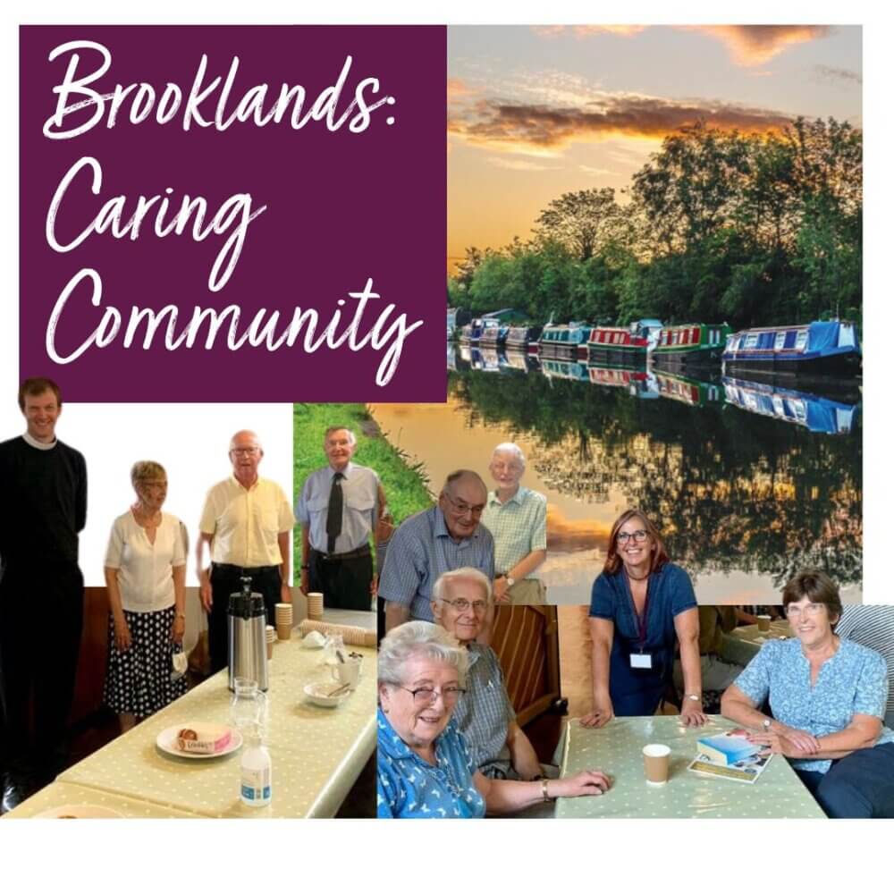 A community group of seniors smiling around a table, with a canal and boats at sunset in the background. Text: "Brooklands: Caring Community". - Home Instead