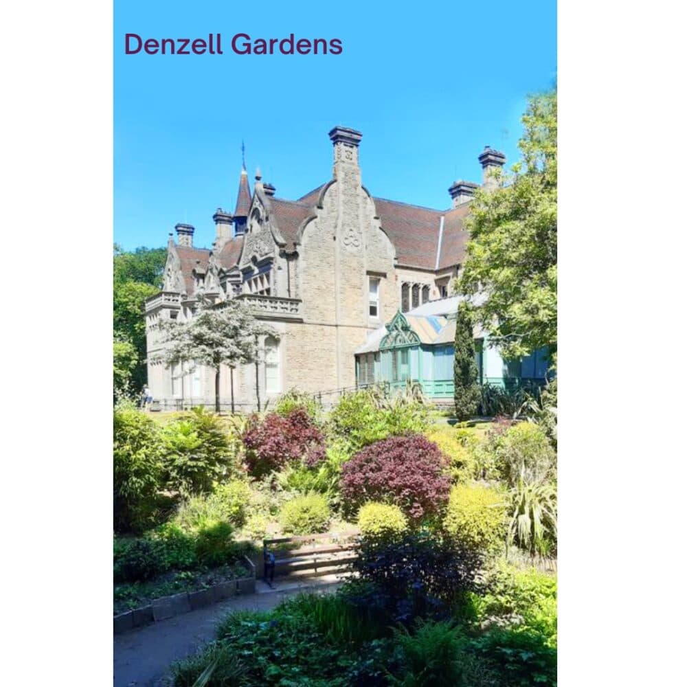 Historic mansion surrounded by lush gardens under a clear blue sky at Denzell Gardens. - Home Instead