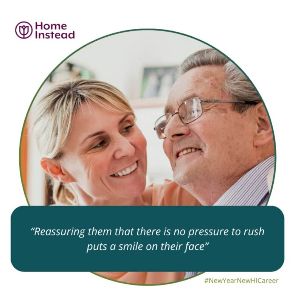 A caregiver smiling at an elderly man with glasses. Caption: "Reassuring them that there is no pressure to rush puts a smile on their face. - Home Instead