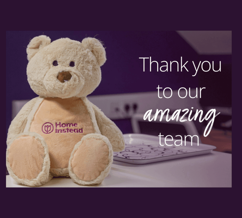 A teddy bear with "Home Instead" logo and text "Thank you to our amazing team" in white on a dark purple background. - Home Instead