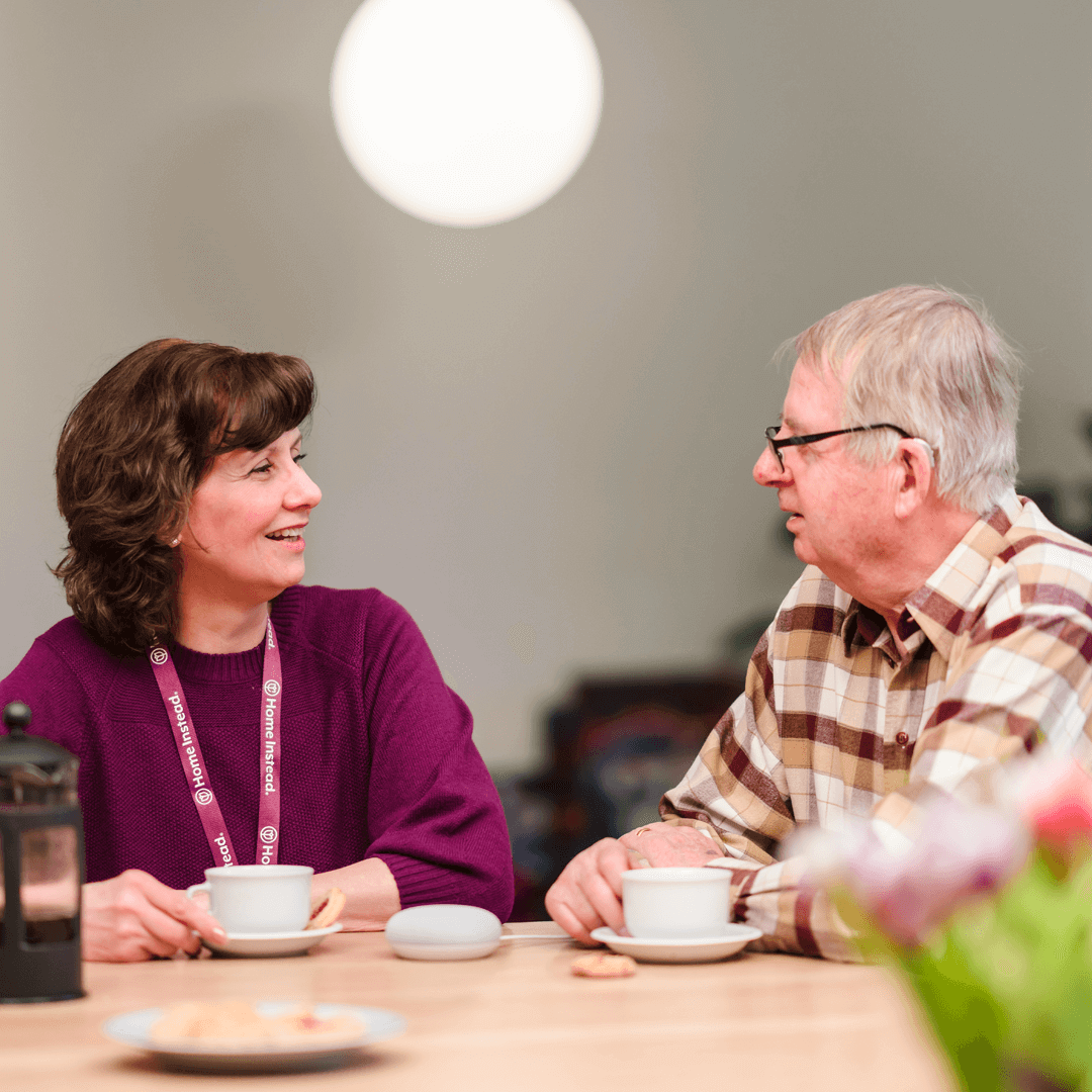Homeinstead care professional drinking tea with her client