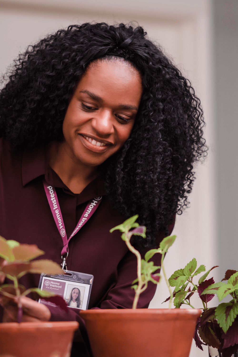 home instead care professional tending to her clients plants