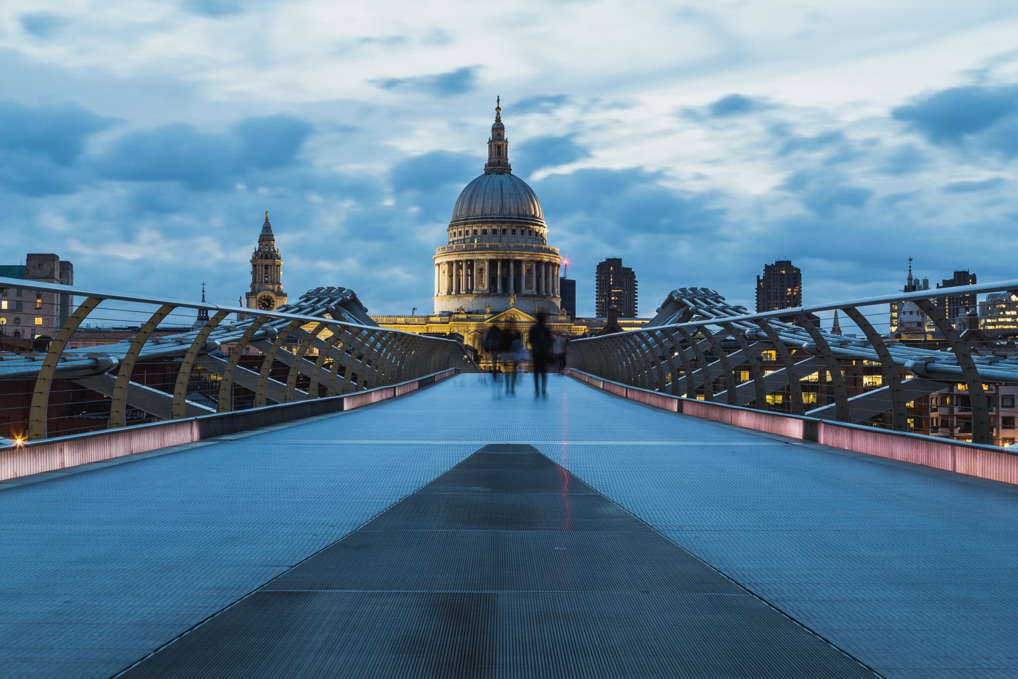 St. Paul's Cathedral viewed from the Millenium Bridge in London during an evening with a cloudy sky. - Home Instead