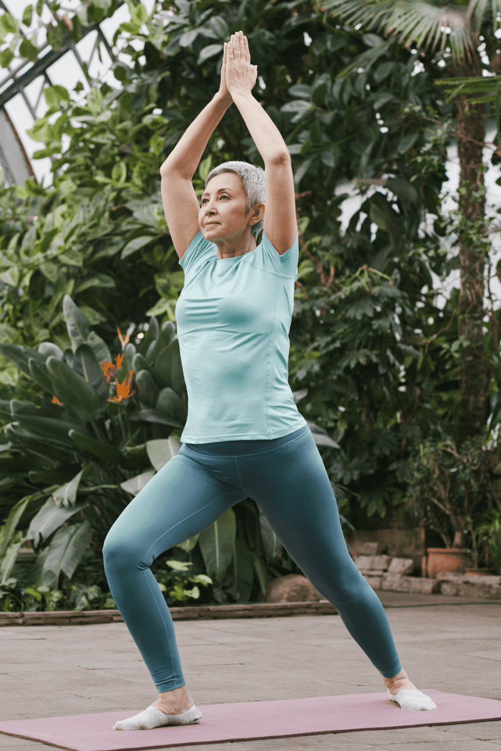 Senior lady enjoying a tai chi exercise class outdoors