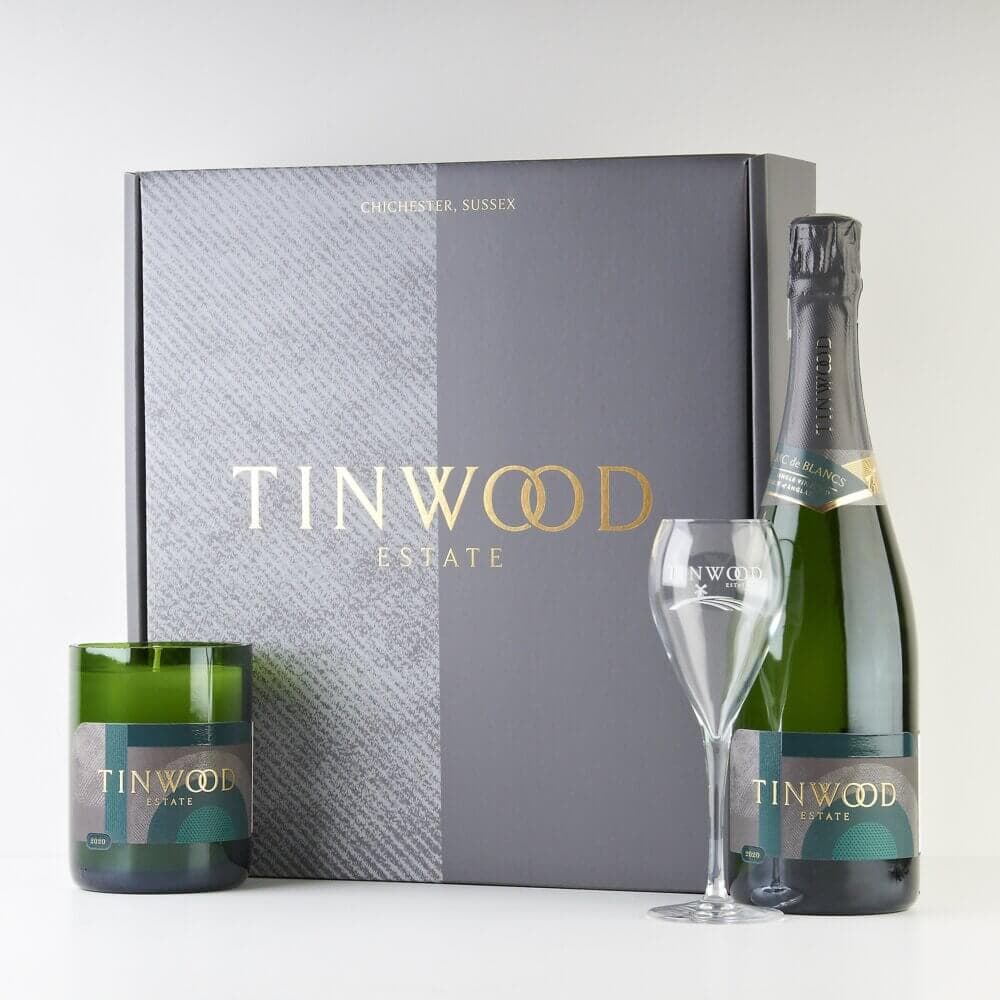 Tinwood Estate gift set with a candle, wine glass, bottled sparkling wine, and stylish packaging. - Home Instead