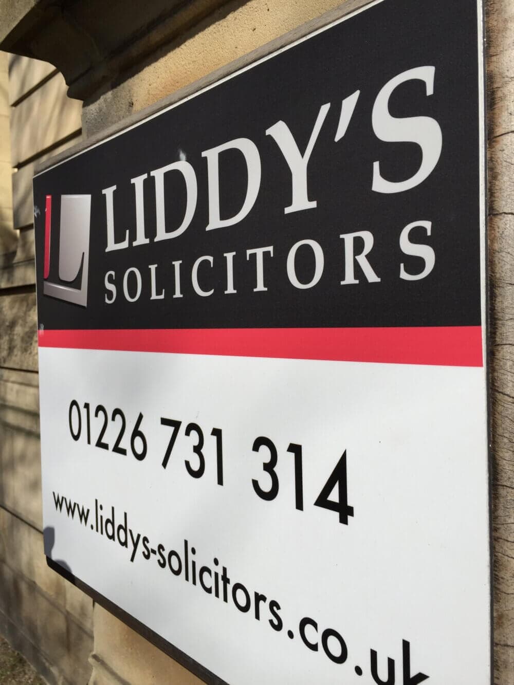 Sign for Liddy's Solicitors with contact details: 01226 731 314 and website www.liddys-solicitors.co.uk. - Home Instead