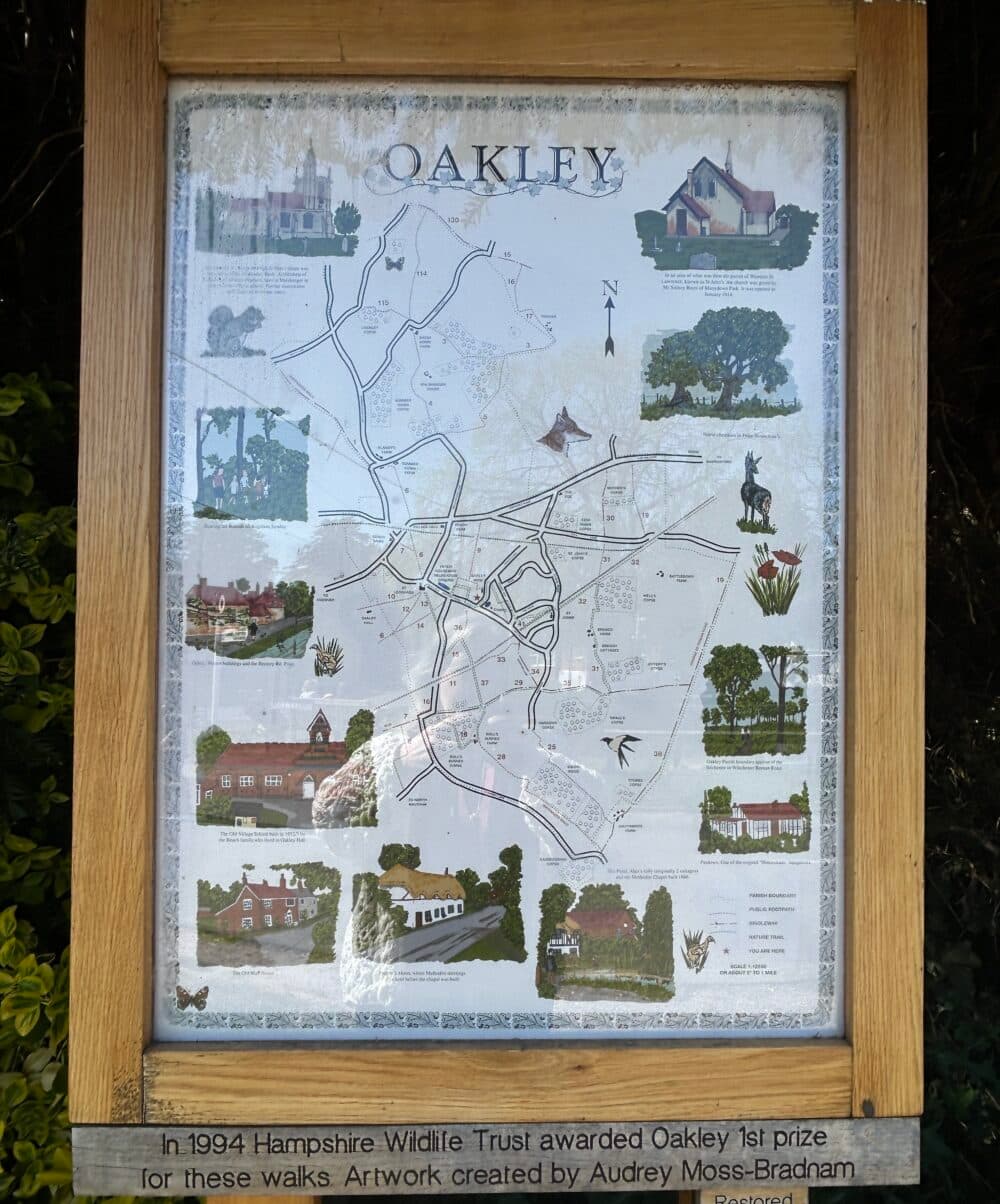 Sign with walkers' map of the area around Oakley showing footpaths and nature trails in the area and pictures of local scenes around the outside