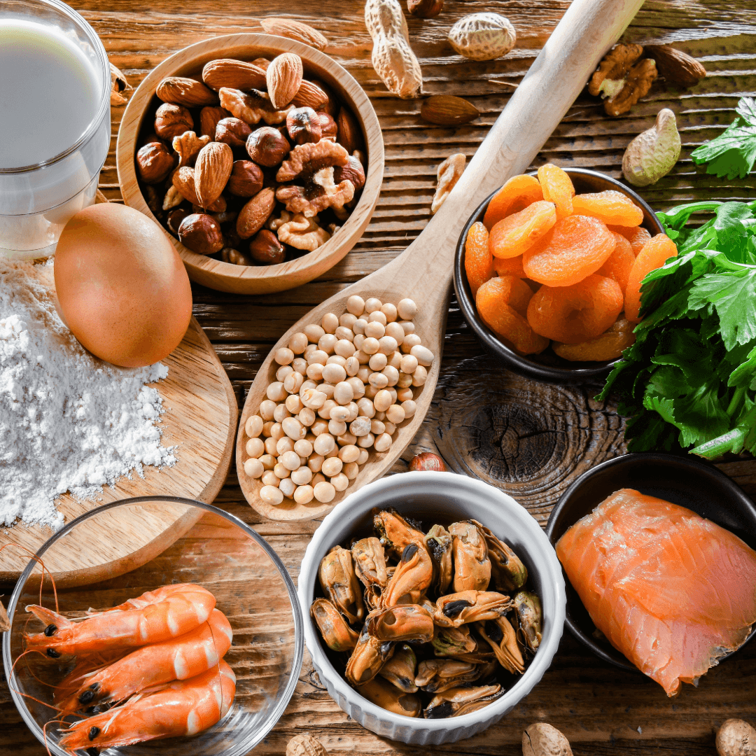 A variety of foods, including milk, nuts, an egg, flour, dried apricots, celery, shrimp, mussels, and salmon. - Home Instead