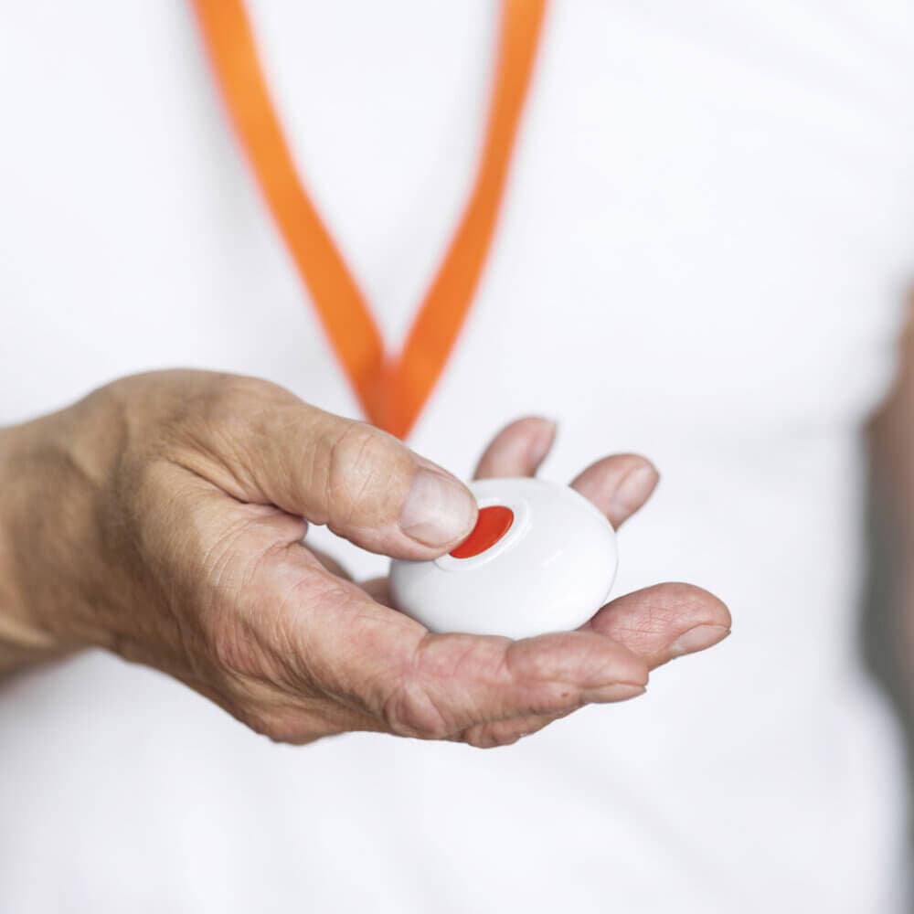 hand holding a personal fall alarm