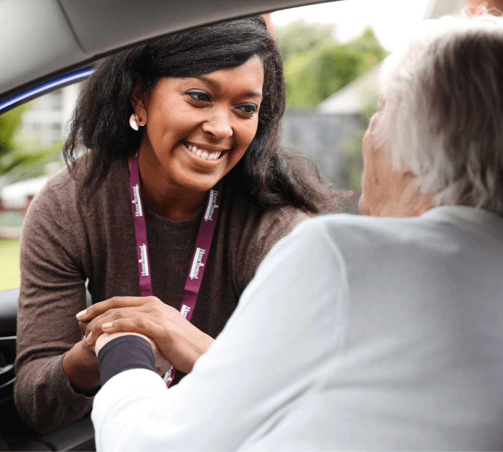 Home Instead Southampton Care Professional helping hand with client