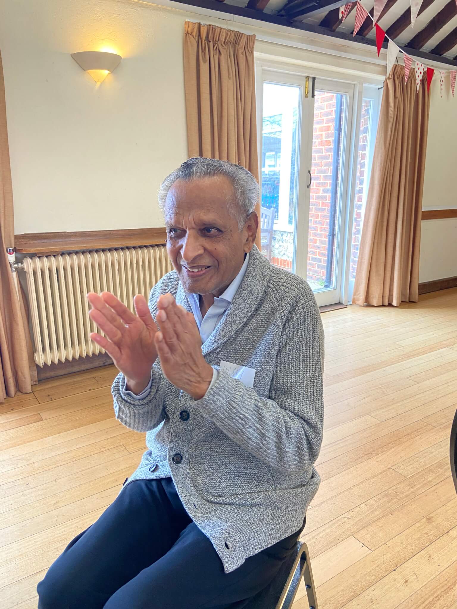 Home Instead elderly client enjoys seated exercise