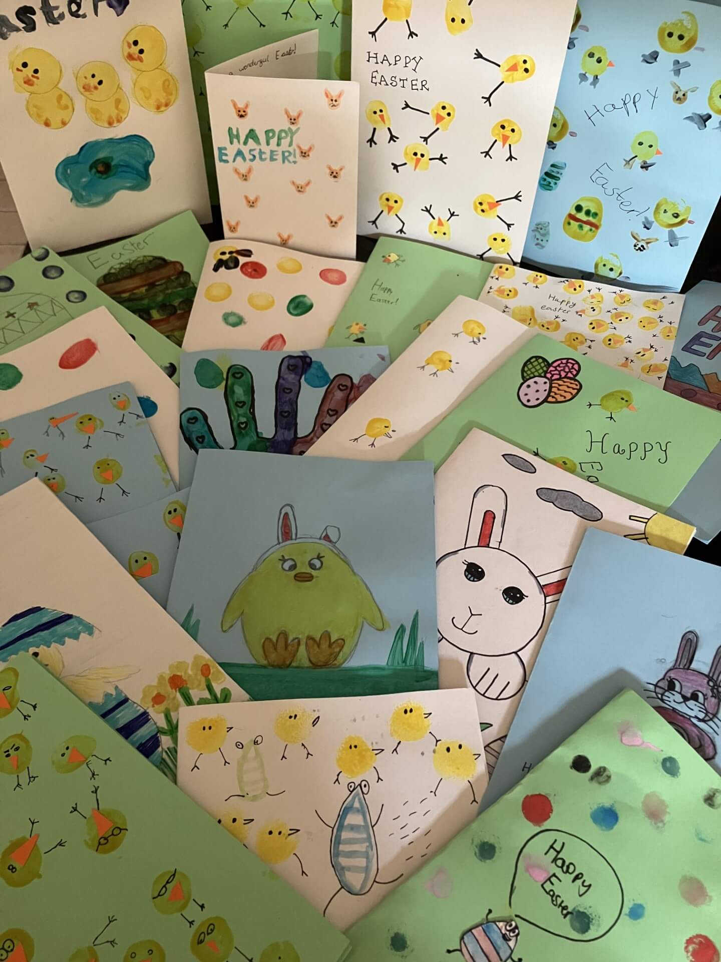 A collection of handmade Easter cards featuring drawings of chicks, bunnies, eggs, and "Happy Easter" messages. - Home Instead