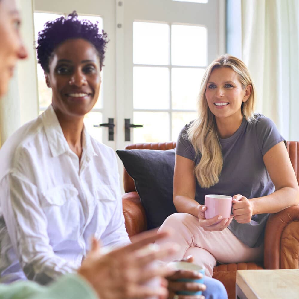 group of ladies chatting over tea together