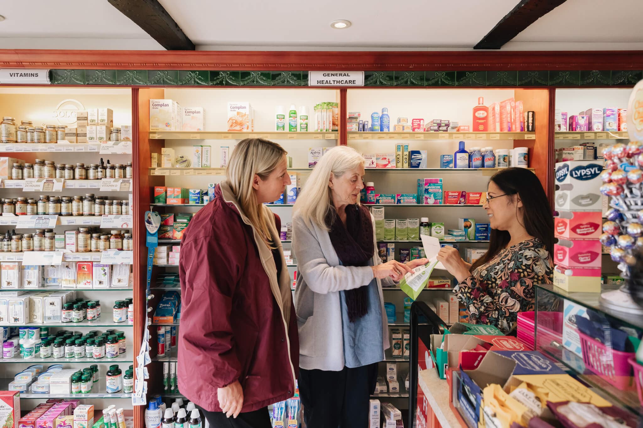 Older lady with carer seeking support from pharmacist