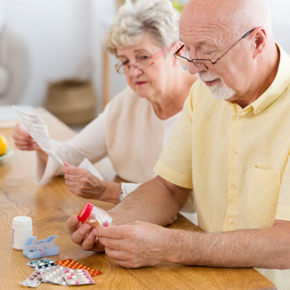 elderly couple reviewing medication