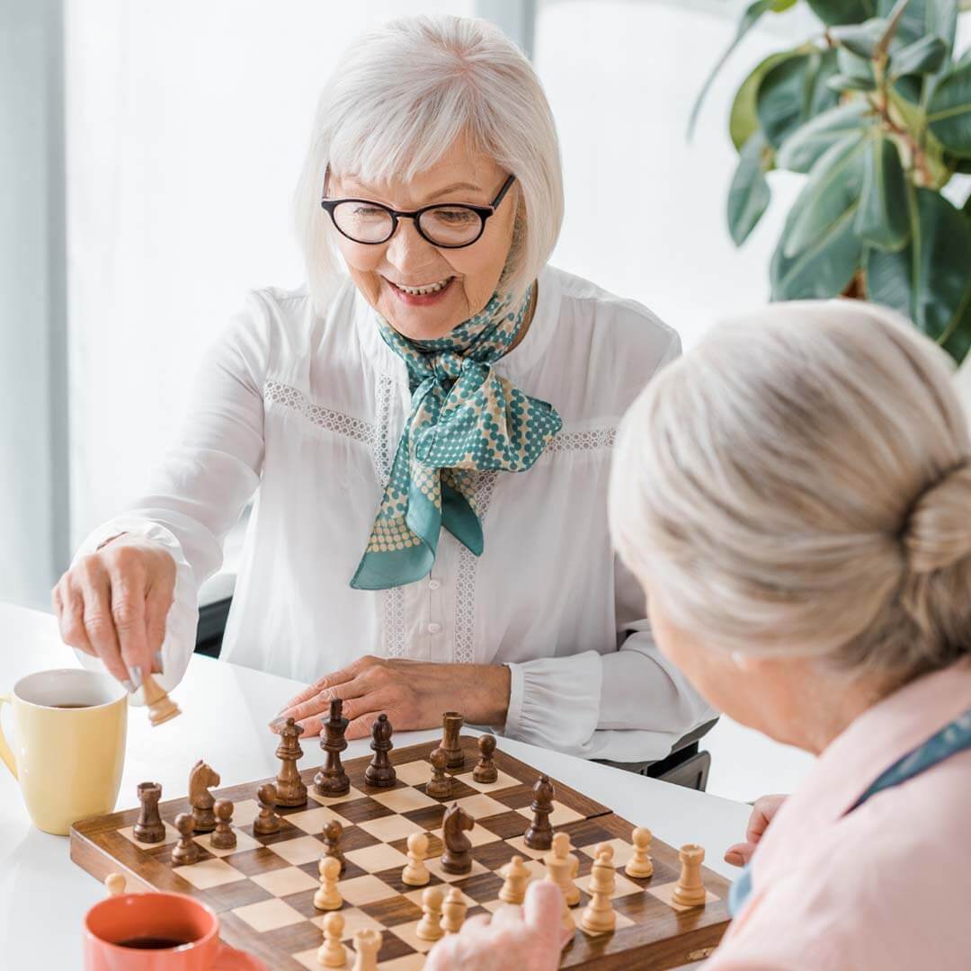 two older ladies playing chess together