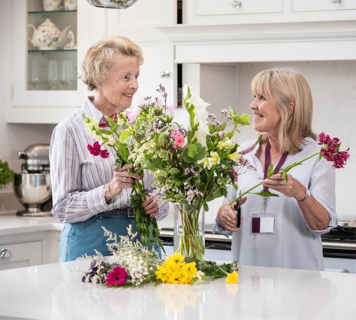Home Instead Poole Care Professional helping client with flowers