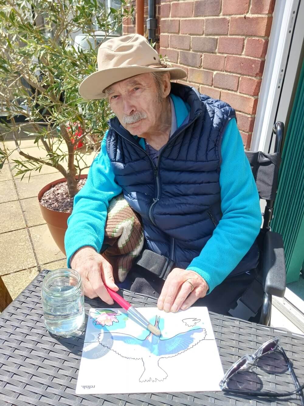 Older client enjoying painting activity