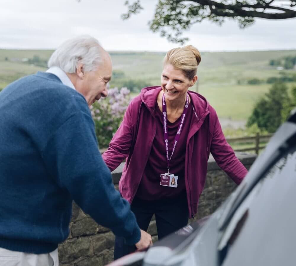 Home Instead Southampton Care Professional with client helping them into car