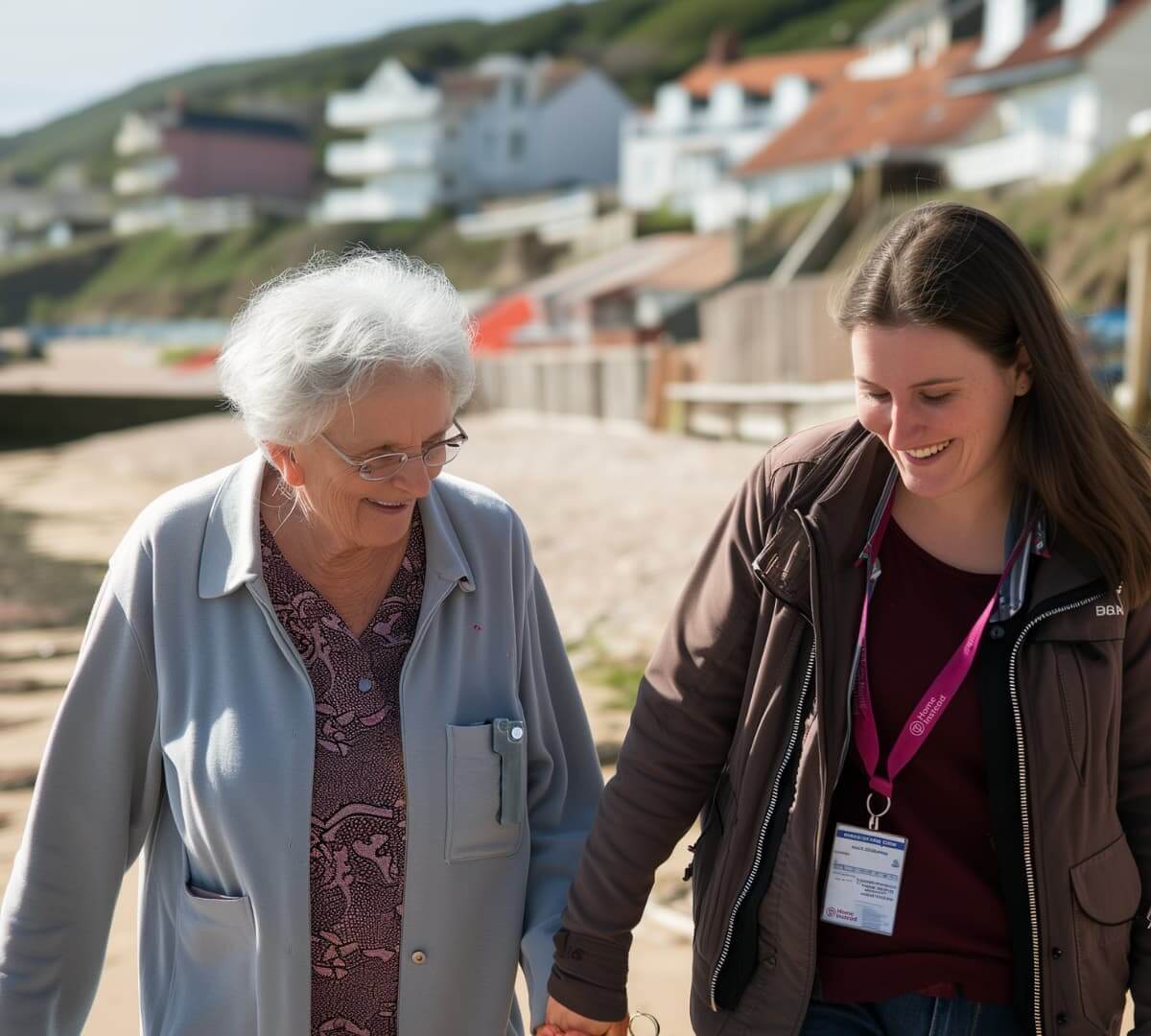 Home Instead Poole Care Professional enjoying a walk at Bournemouth beach with client