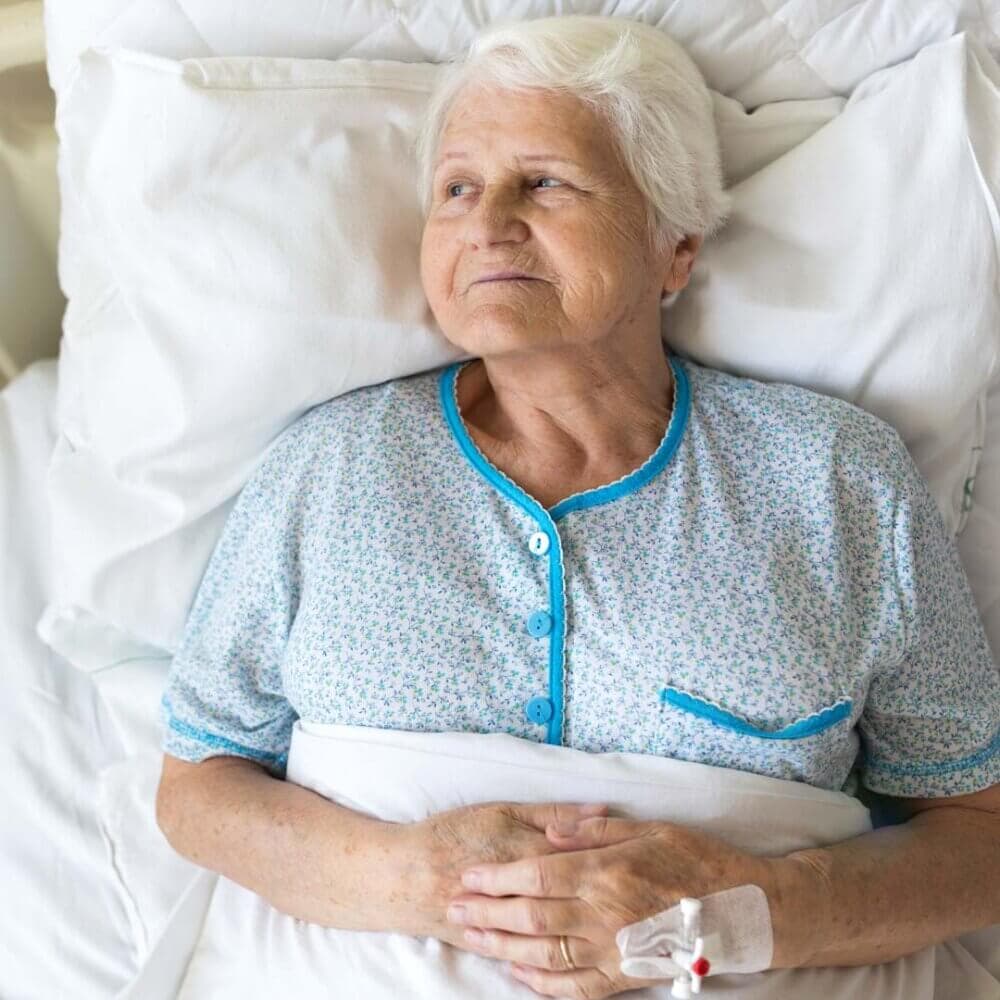 older lady lying and waiting in hospital bed