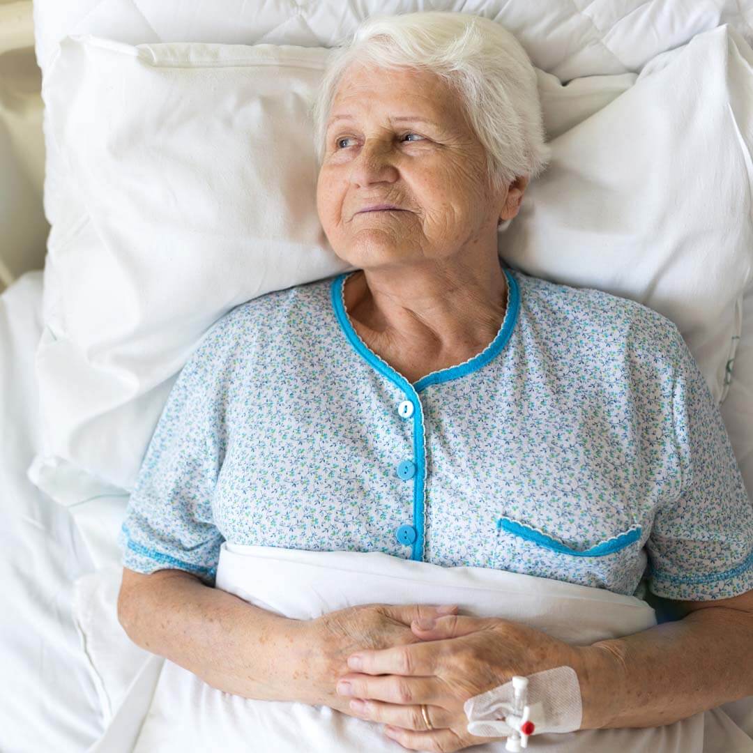 older lady lying and waiting in hospital bed