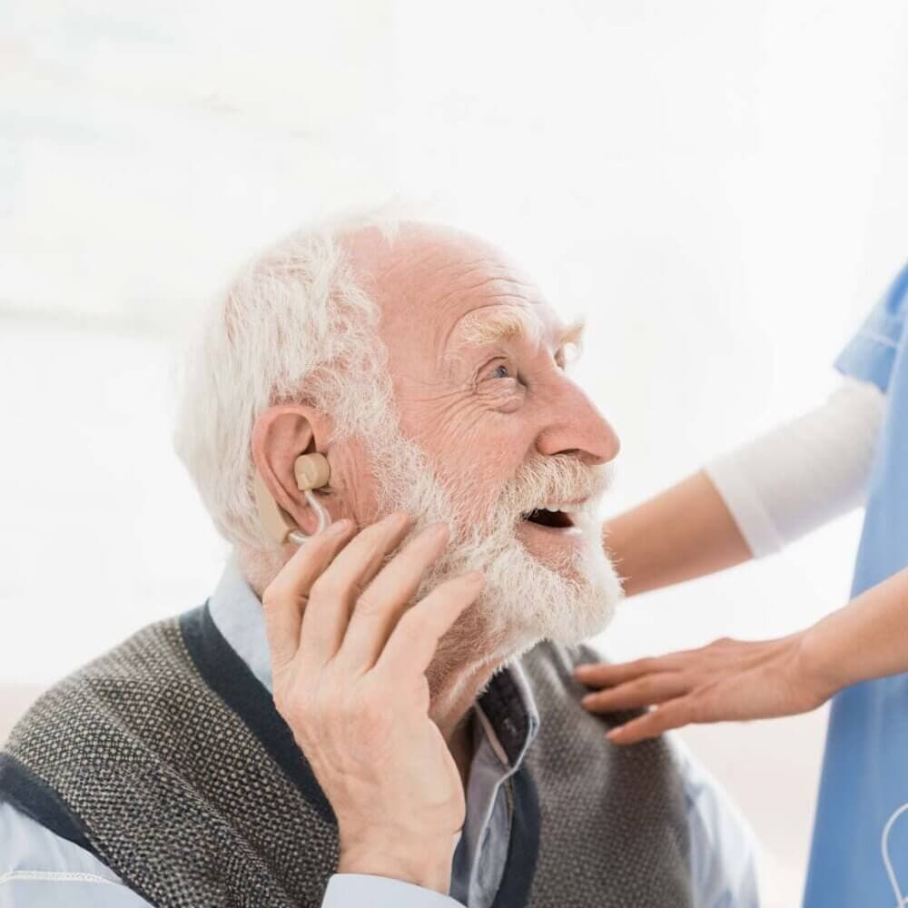 elderly man testing his hearing aids