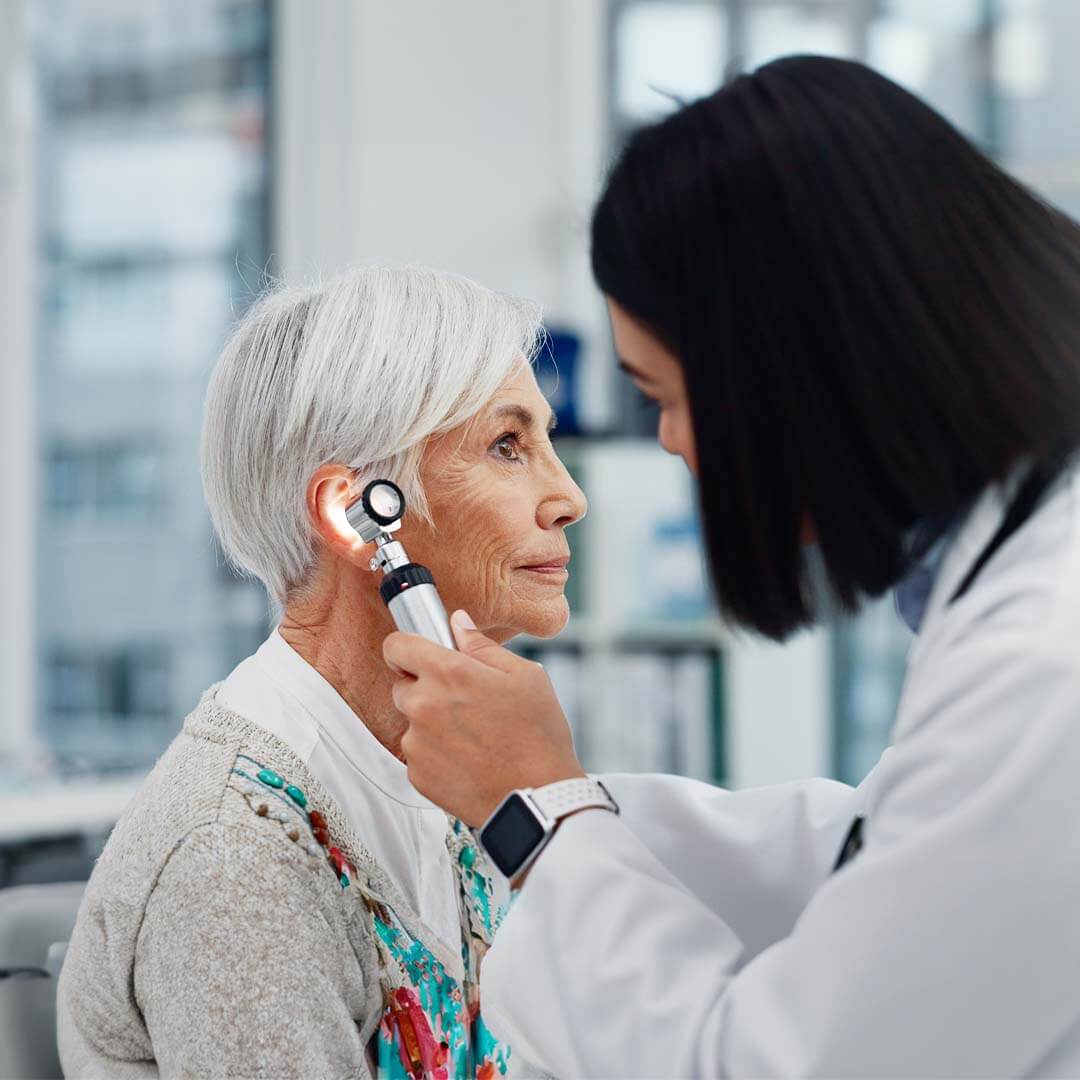 senior lady having a hearing check